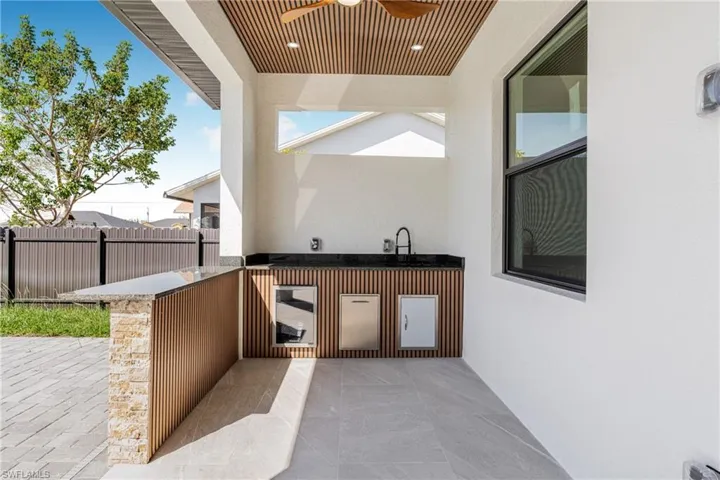 View of patio featuring ceiling fan, fence, and area for grilling
