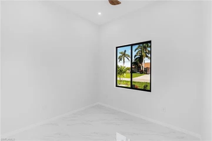 Empty bedroom featuring recessed lighting, marble finish floor, ceiling fan, and baseboards