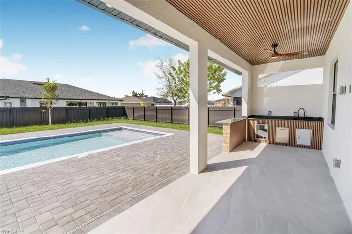 View of pool with a patio, a fenced backyard, area for grilling, a ceiling fan, and a fenced in pool