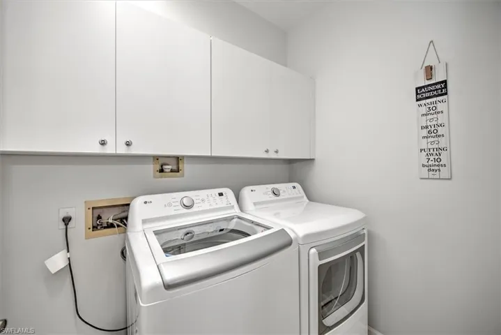 Washroom with cabinets and independent washer and dryer