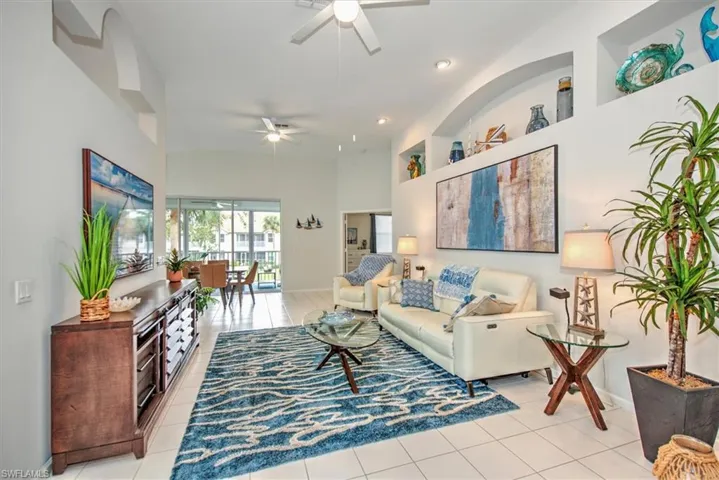 Living room featuring ceiling fan and light tile patterned floors