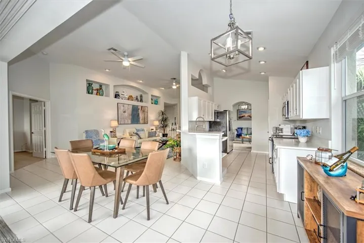Tiled dining area featuring ceiling fan