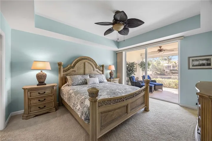 Bedroom with a raised ceiling, access to outside, and NEW light colored carpet
