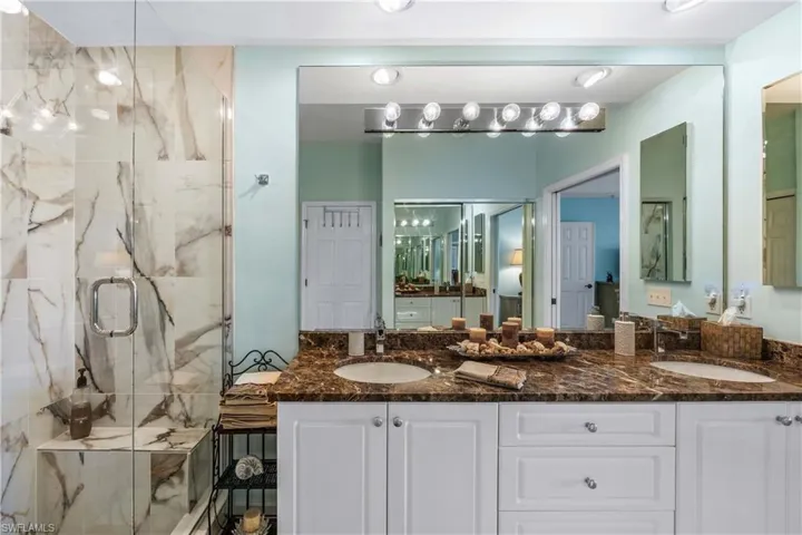 Bathroom featuring double vanity and a NEW marble finish shower