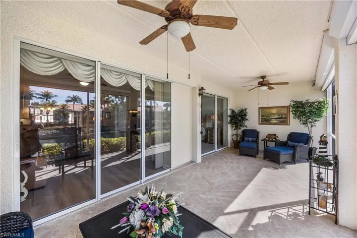 Sunroom LANAI  with ceiling fan, an outdoor living space, and a patio area