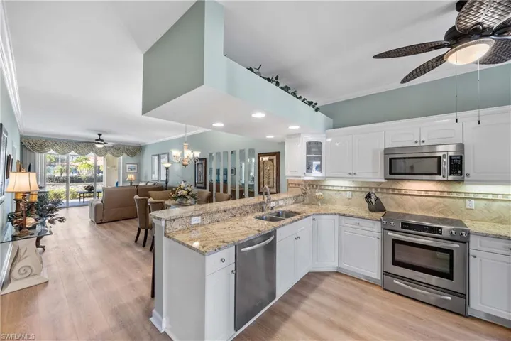 Kitchen with granite counters, light cabinets ,stainless steel appliances