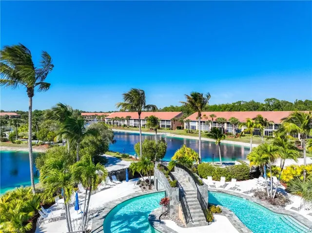 Community pool with a patio area and a water view