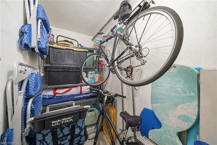 Private storage closet with beach gear included — chairs, umbrella, cooler, and bikes ready to go.