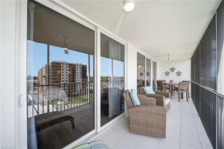 The lanai runs the length of the unit. Gulf breeze, open sky, and no upstairs neighbors — ever.