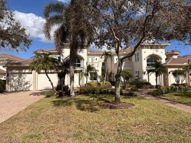 Mediterranean / spanish house with a balcony, a front yard, and a garage