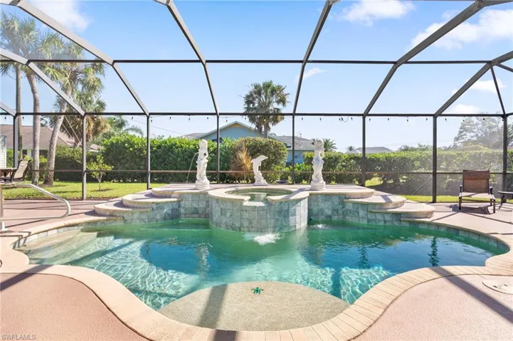 View of pool with an in ground hot tub, a patio area, and a lanai