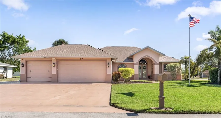 Ranch-style home with a front lawn and a garage