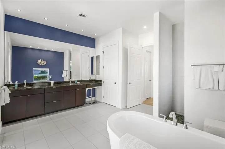 The ground floor Master Suite Bathroom with twin basins, separate walk in shower + separate tub