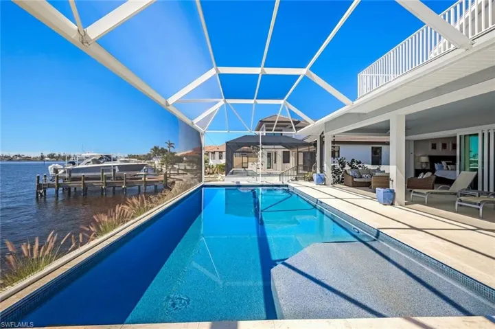 View of the Pool deck with sun shelf in pool