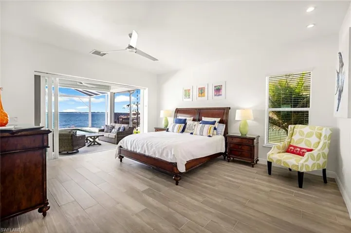 The ground floor Master Suite with sliding doors to the pool deck