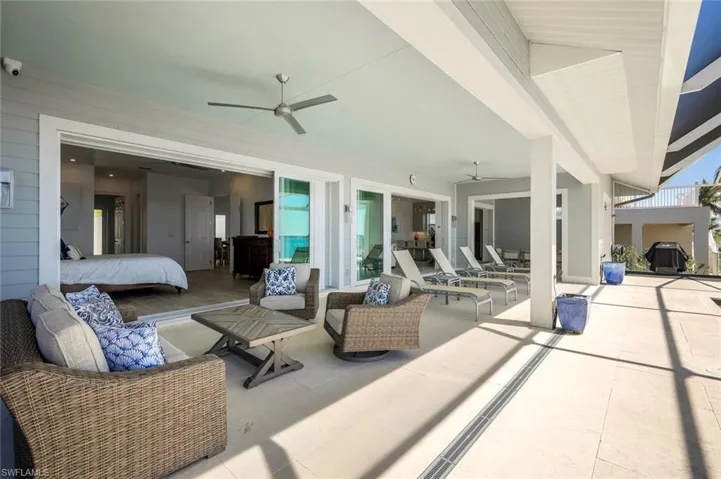 The oversized pool deck shaded area runs the entire length of the house to provide multiple options for seating and entertaining