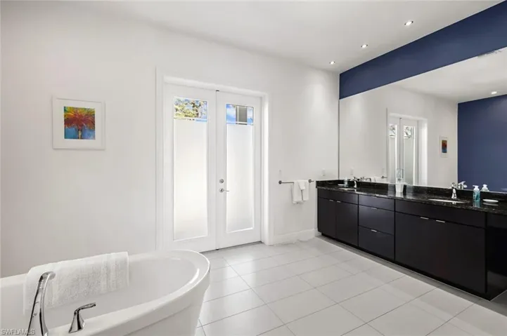 A view of the ground floor Master Ensuite Bathroom with twin basins, walk in shower & separate tub