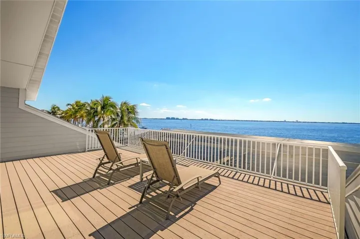 The upper story Master Suite has its' own private balcony with views over the river and pool deck