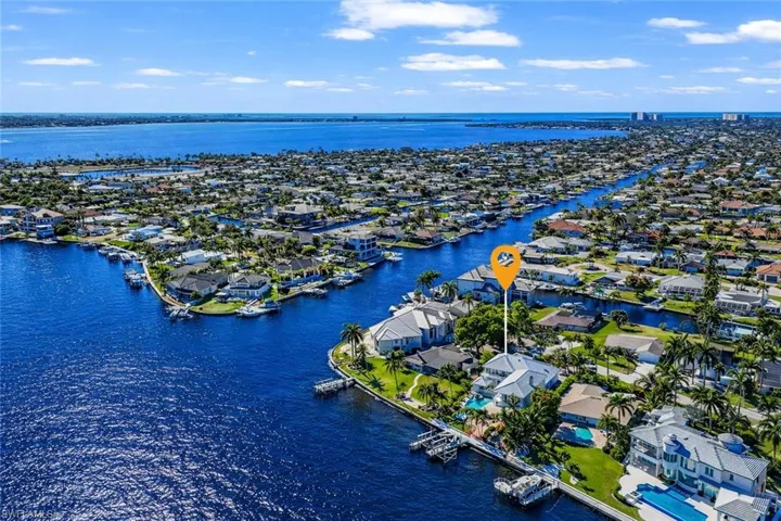 Aerial perspective of suburban area featuring a large body of water