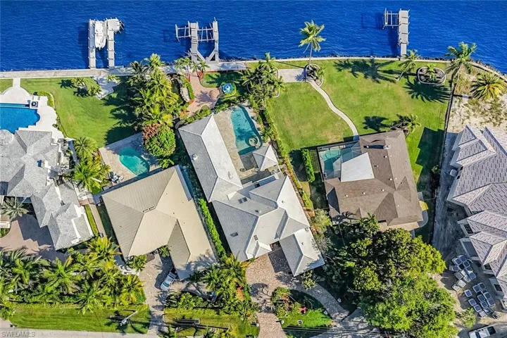 Aerial perspective of suburban area featuring a nearby body of water