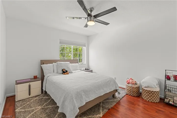 Bedroom featuring ceiling fan and wood-type flooring