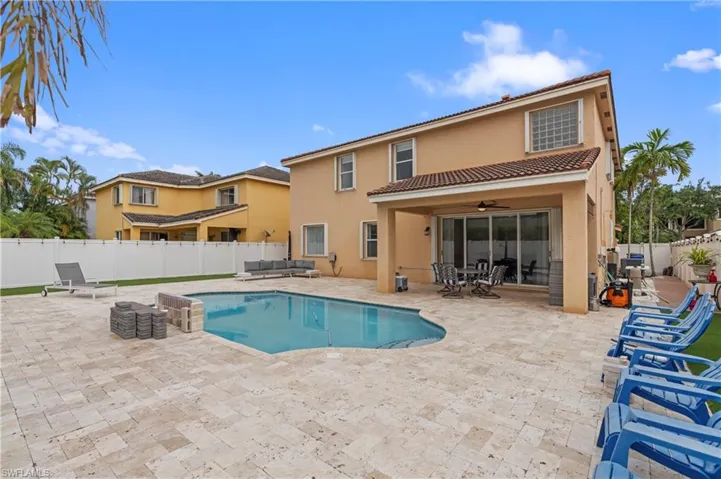 View of swimming pool featuring a patio and ceiling fan