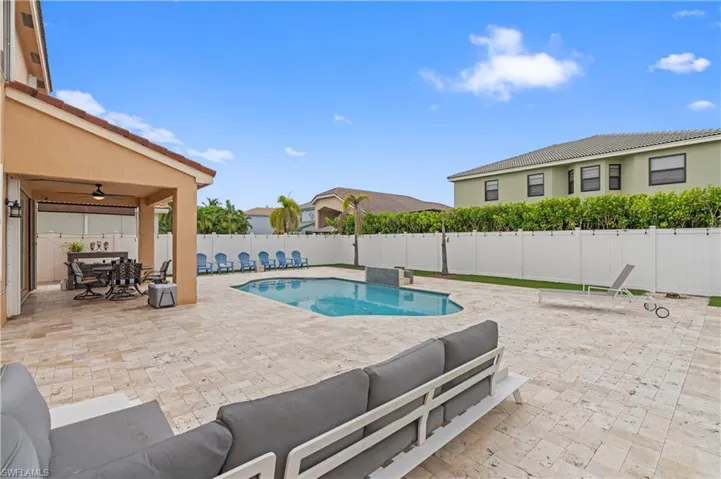 View of swimming pool with a patio, ceiling fan, and an outdoor hangout area