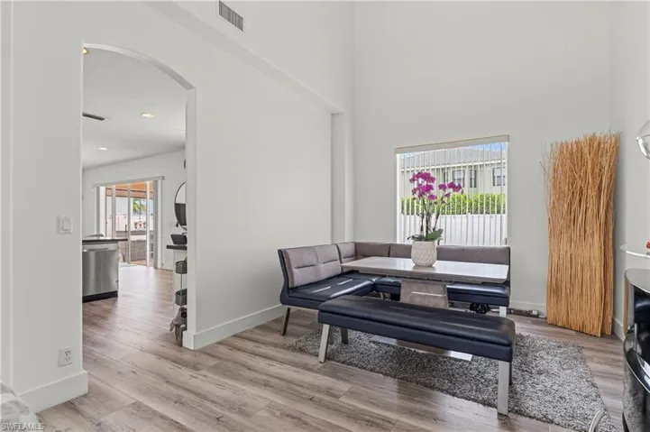 Sitting room featuring a high ceiling and hardwood / wood-style floors