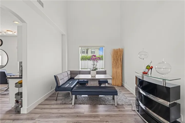 Living area featuring hardwood / wood-style floors and a high ceiling