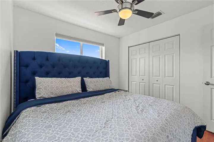 Bedroom featuring ceiling fan and a closet