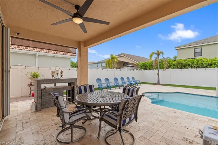 View of patio / terrace with a fenced in pool and ceiling fan
