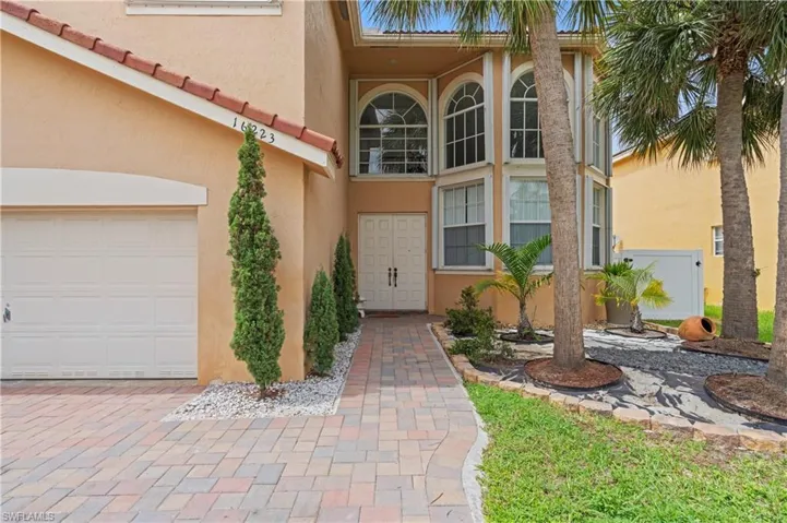 View of exterior entry with a garage