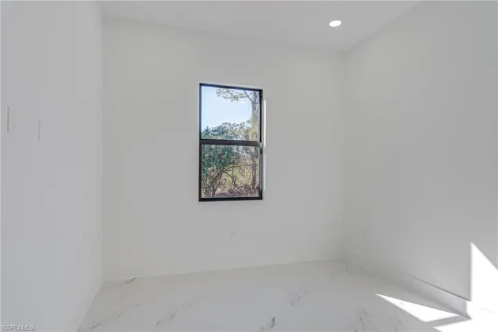 Empty room with recessed lighting and marble finish floors