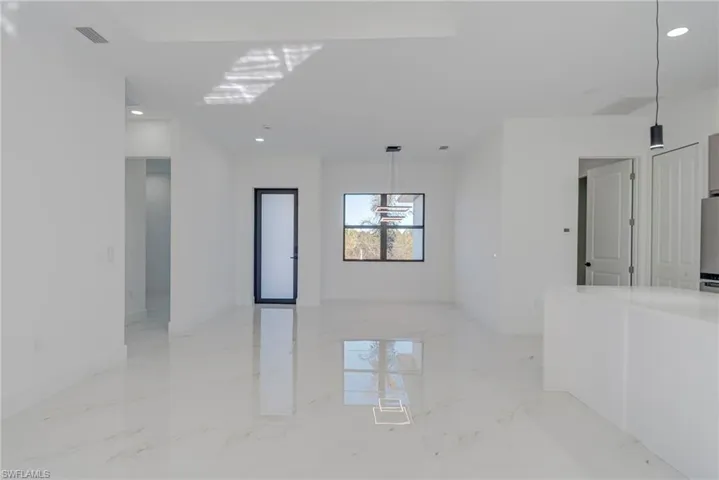 Spare room featuring light marble finish floors and recessed lighting