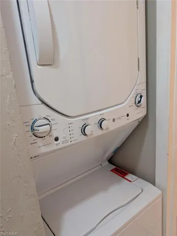 Washroom featuring laundry area and stacked washer and dryer