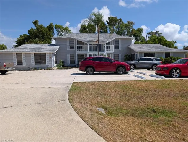 Tri-level home with a front yard and driveway