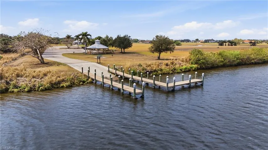 Dock area featuring a water view and a boat ramp
