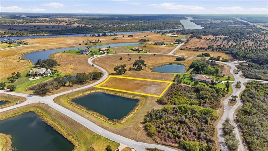 Aerial view of property's location featuring a large body of water and property parcel outlined