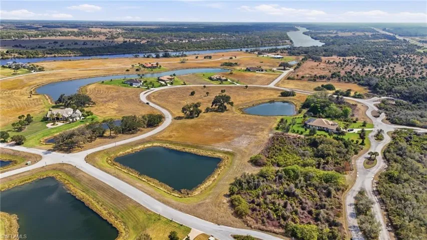 Aerial view of property's location with a nearby body of water