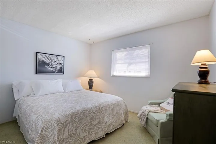 Carpeted bedroom featuring a textured ceiling