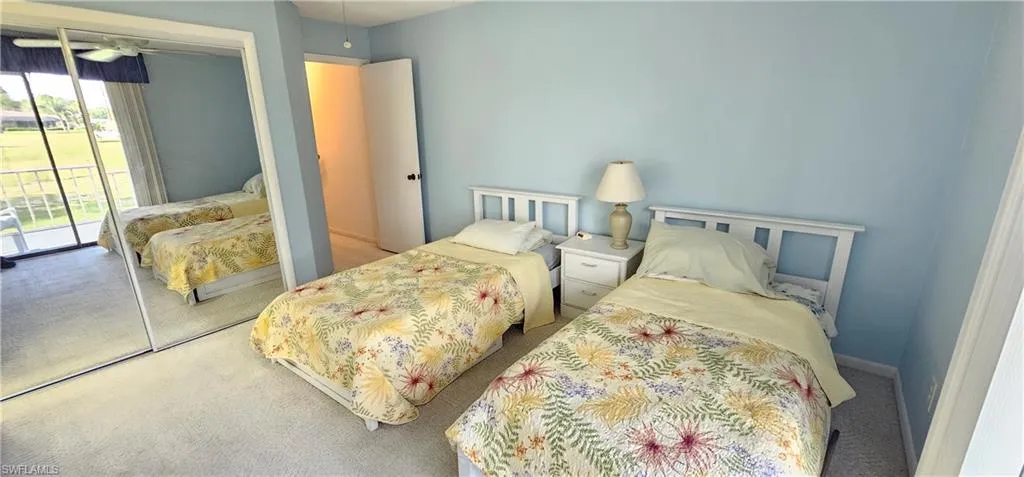 Carpeted bedroom featuring access to outside and a closet