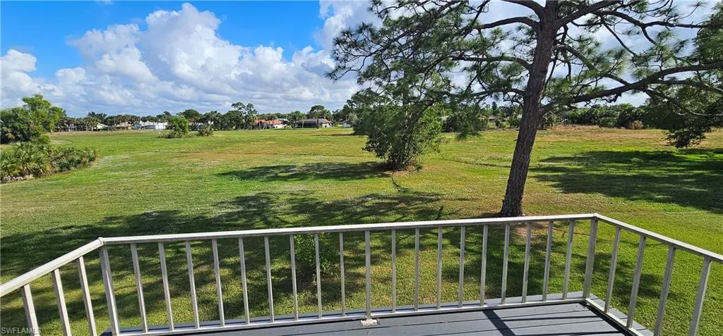 View of yard featuring a balcony