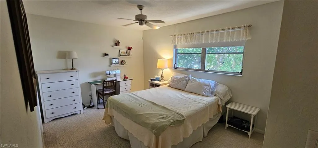 Carpeted bedroom with ceiling fan