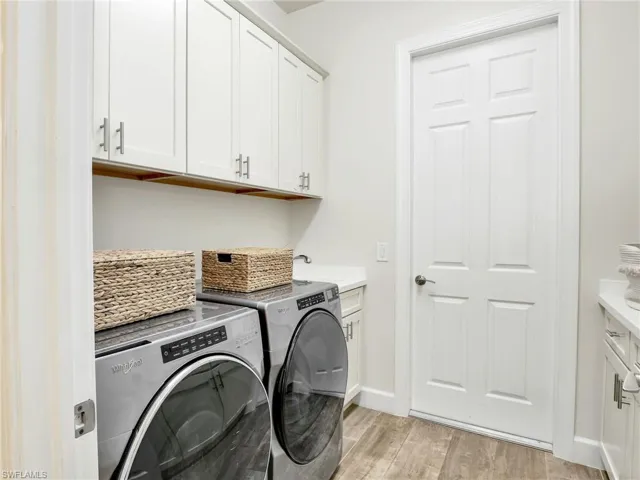 Laundry room with built in cabinets and laundry tub