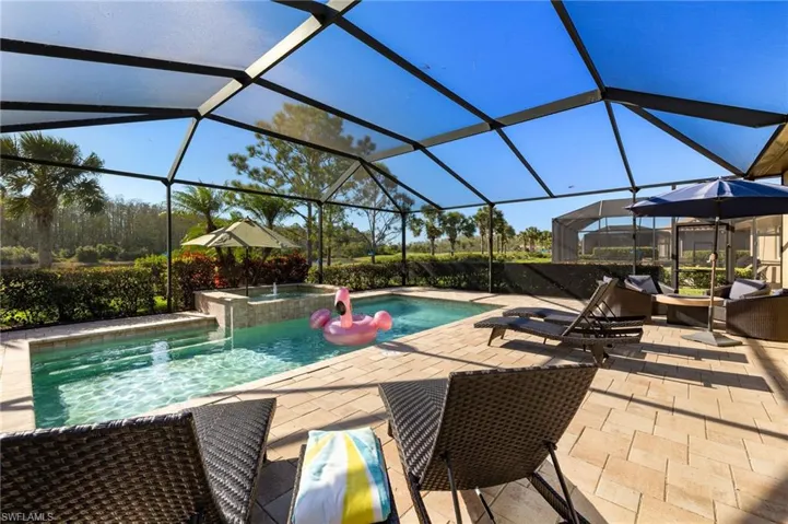 View of pool with a pool with connected hot tub and a patio area