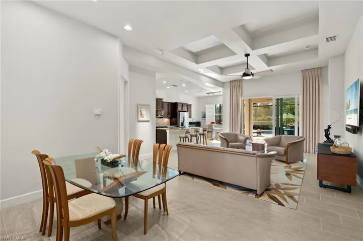 Dining area featuring baseboards, visible vents, coffered ceiling, recessed lighting, and ceiling fan