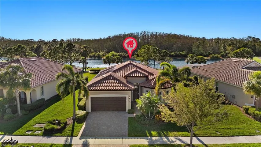 Drone / aerial view with a wooded view and a water view