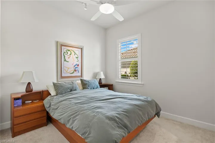 Bedroom featuring baseboards, carpet, and ceiling fan