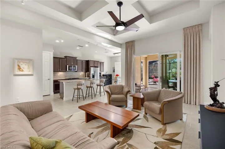 Living area featuring beam ceiling, recessed lighting, coffered ceiling, and ceiling fan