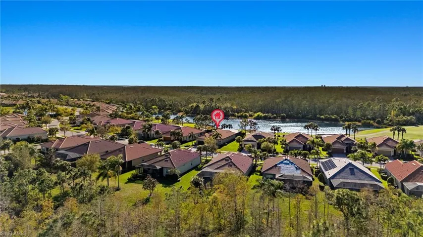Drone / aerial view with a wooded view, a residential view, and a water view